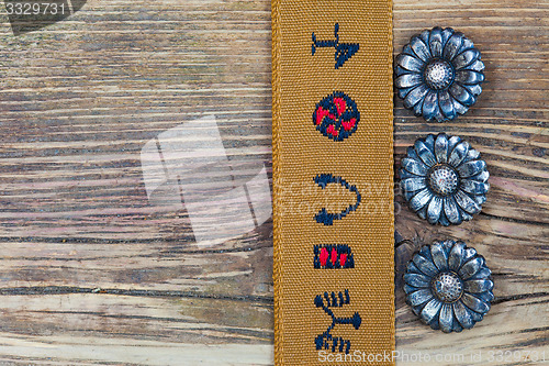 Image of vintage buttons and old tape with embroidered ornaments