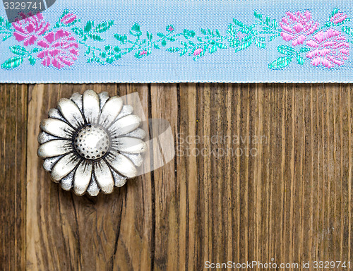 Image of vintage aqua color tape with embroidered ornaments and old butto