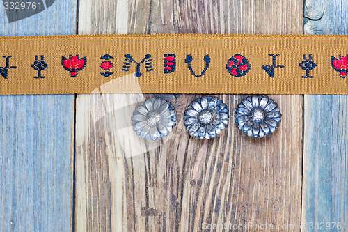 Image of vintage tape with embroidered ornaments and old buttons