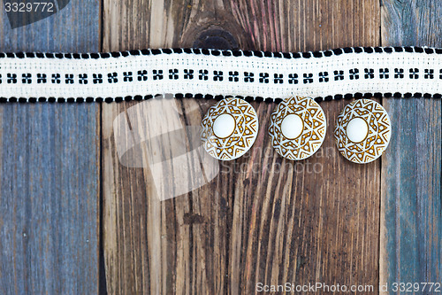 Image of Vintage tape with embroidered pattern and three ancient buttons