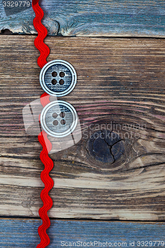 Image of vintage red tape and two old classic buttons