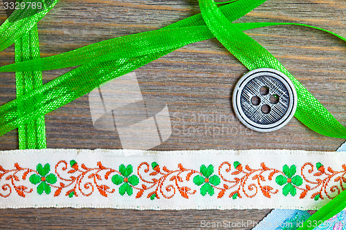 Image of vintage embroidered band and tape with old classic button