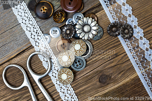 Image of vintage buttons, lace, and a dressmaker scissors