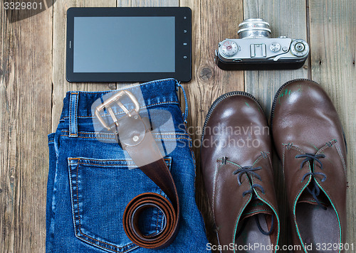 Image of digitizer, rangefinder camera, brown boots, leather belt and blu