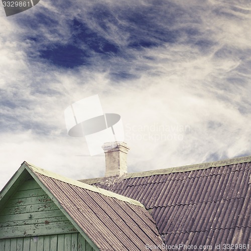 Image of old house with a tiled roof and chimney