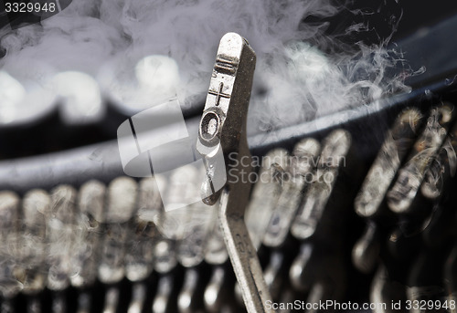 Image of 0 and equal hammer - old manual typewriter - mystery smoke