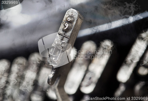 Image of IJ hammer - old manual typewriter - mystery smoke