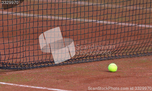 Image of Tennis ball on the orange tenniscourt