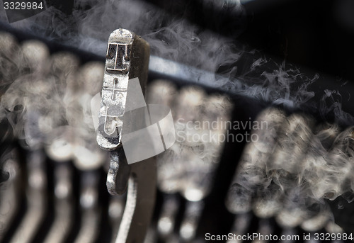 Image of T hammer - old manual typewriter - mystery smoke