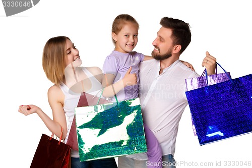 Image of Happy family with shopping bags standing at studio 