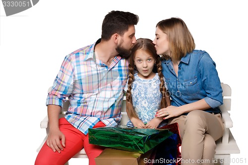 Image of Happy family with shopping bags sitting at studio 