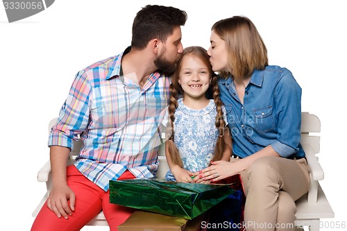 Image of Happy family with shopping bags sitting at studio 