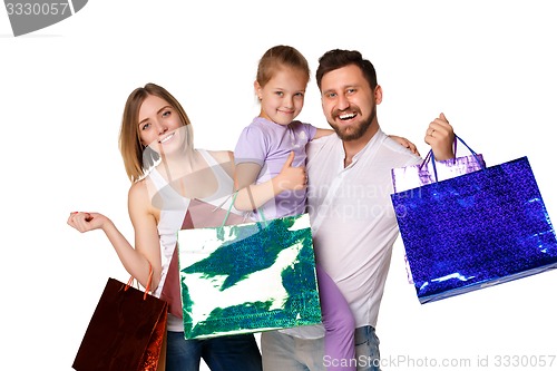 Image of Happy family with shopping bags standing at studio 