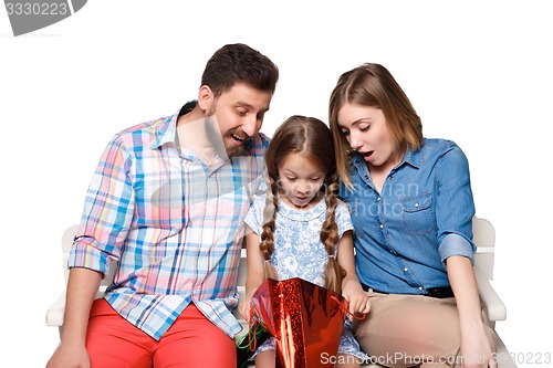 Image of Happy family with shopping bags sitting at studio 