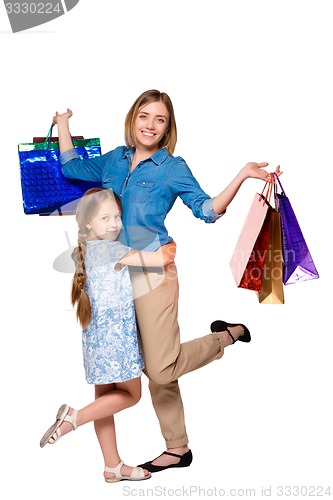 Image of Happy a mother and daughter with shopping bags standing at studio 