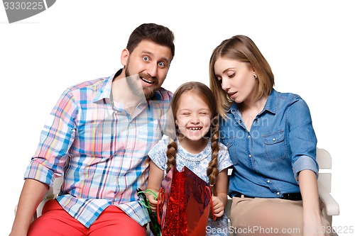 Image of Happy family with shopping bags sitting at studio 