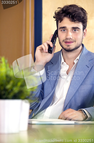Image of Receptionist Using Cordless Phone