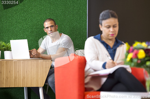 Image of Confident Businessman Sitting In Lobby