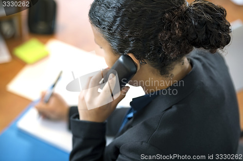 Image of Receptionist Using Phone In Office