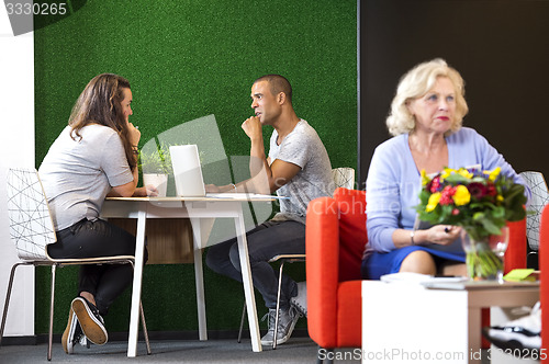 Image of Businesspeople Discussing At Office Lobby