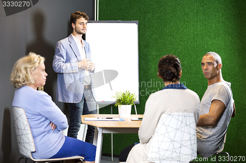 Image of Businesspeople Discussing At Office Lobby