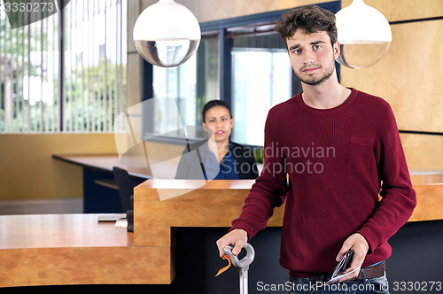 Image of Man Standing At Hotel Reception