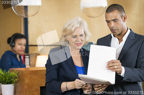 Image of Businesspeople Discussing Over Documents