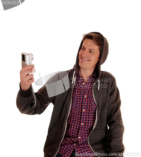 Image of Man in hoody taking selfie.