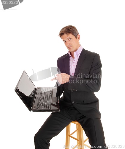 Image of Business man showing on laptop.