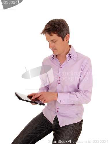 Image of Man playing with tablet pc.