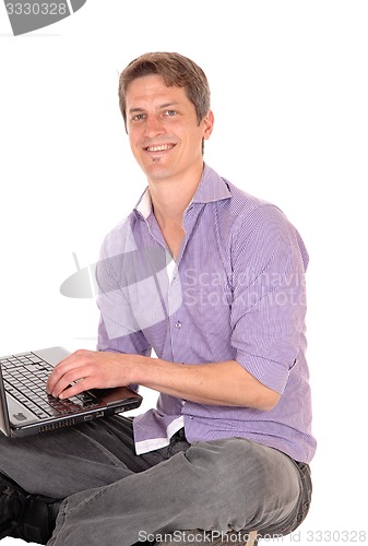 Image of Man working on laptop.