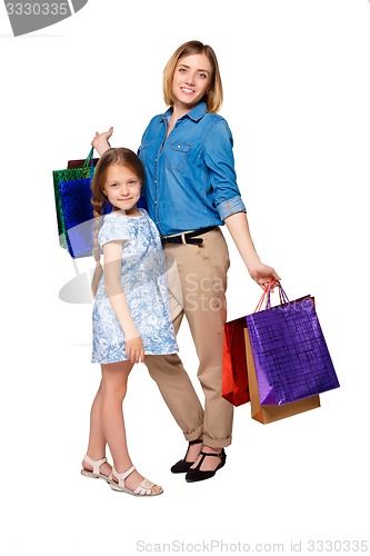 Image of Happy a mother and daughter with shopping bags standing at studio 