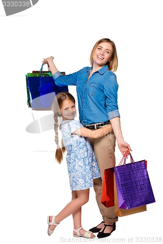 Image of Happy a mother and daughter with shopping bags standing at studio 