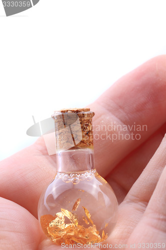 Image of gold in small glass bottle 