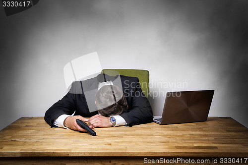 Image of Overworked businessman with gun