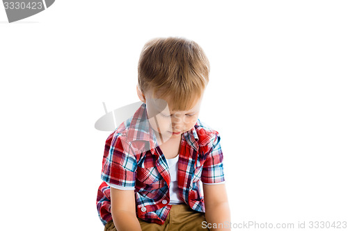 Image of little boy in a plaid shirt over a white