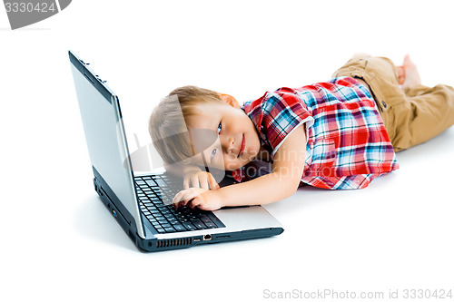 Image of boy in a plaid shirt with a laptop on a white background.