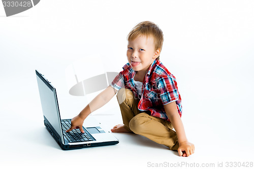 Image of boy in a plaid shirt with a laptop on a white background.