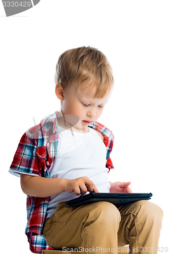 Image of boy in a plaid shirt with a tablet computer