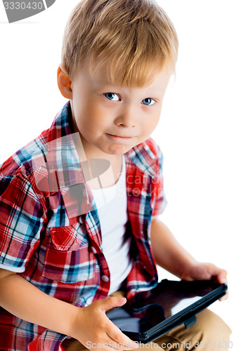 Image of boy in a plaid shirt with a tablet computer