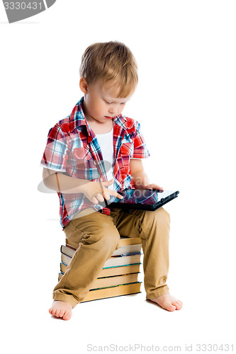 Image of boy in a plaid shirt with a tablet computer