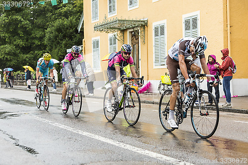 Image of Group of Cyclists Riding in the Rain - Tour de France 2014