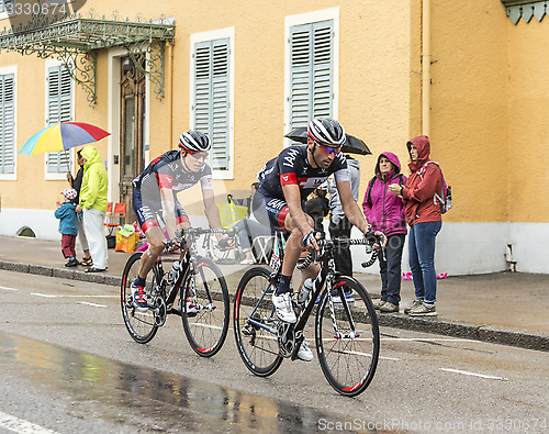 Image of Two Cyclists Riding in the Rain - Tour de France 2014