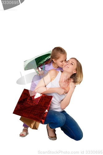 Image of Happy a mother and daughter with shopping bags standing at studio 