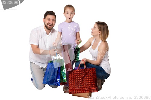Image of Happy family with shopping bags sitting at studio 