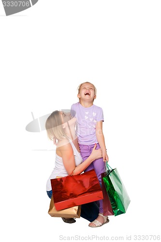 Image of Happy a mother and daughter with shopping bags standing at studio 