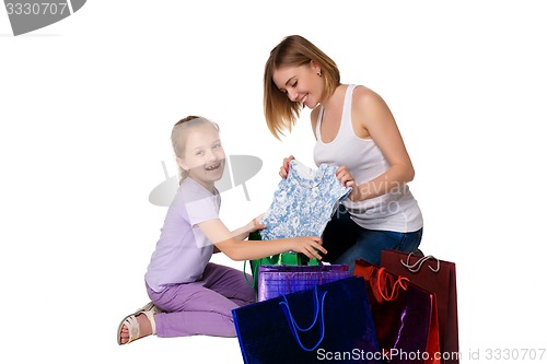 Image of Happy a mother and daughter with shopping bags sitting at studio 