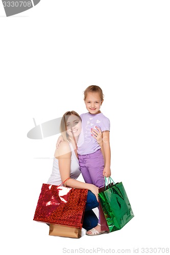 Image of Happy a mother and daughter with shopping bags standing at studio 