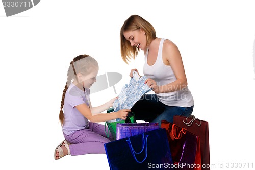 Image of Happy a mother and daughter with shopping bags sitting at studio 