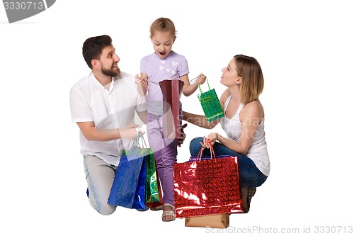 Image of Happy family with shopping bags sitting at studio 